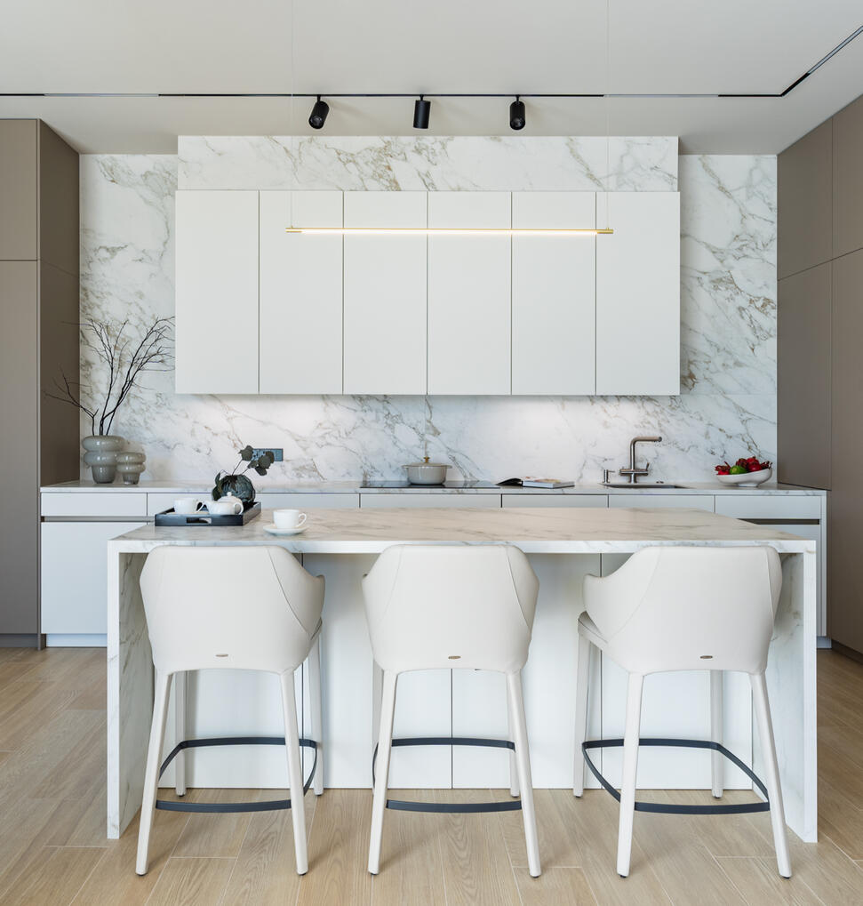 Interior photography of a modern white kitchen with a minimalist design, natural materials and clean architectural lines.