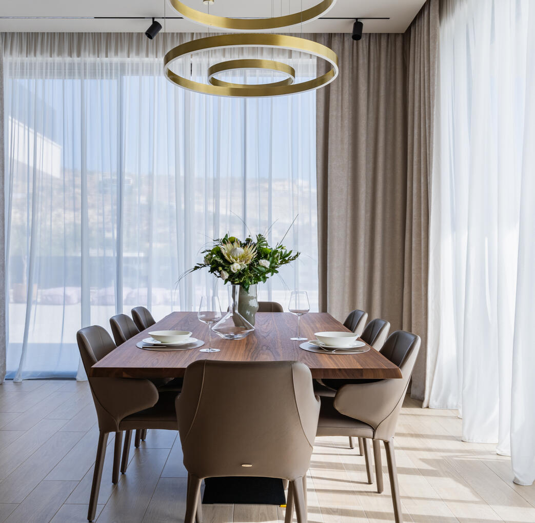 Interior photography of a spacious dining area in a contemporary private home, featuring natural tones, clean lines and abundant natural light.